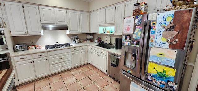 kitchen with exhaust hood, light tile patterned flooring, a sink, light countertops, and stainless steel appliances