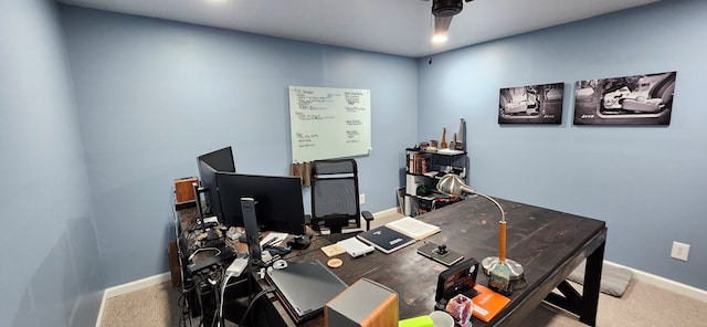 office area with a ceiling fan, baseboards, and carpet