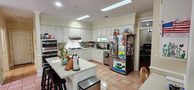 kitchen with a sink, light tile patterned floors, white cabinets, and stainless steel appliances