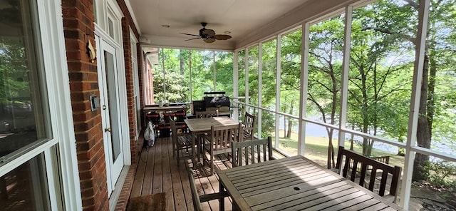 sunroom / solarium with a healthy amount of sunlight, ceiling fan, and outdoor dining space