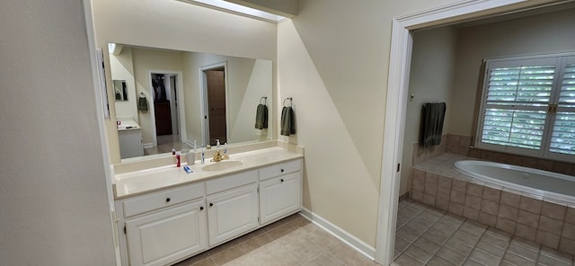 full bath with tile patterned floors, a garden tub, and vanity