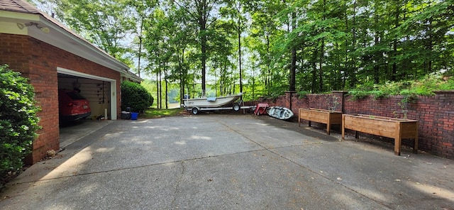 view of parking / parking lot with concrete driveway