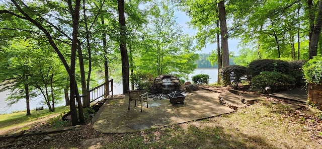 view of patio / terrace with a water view and a fire pit