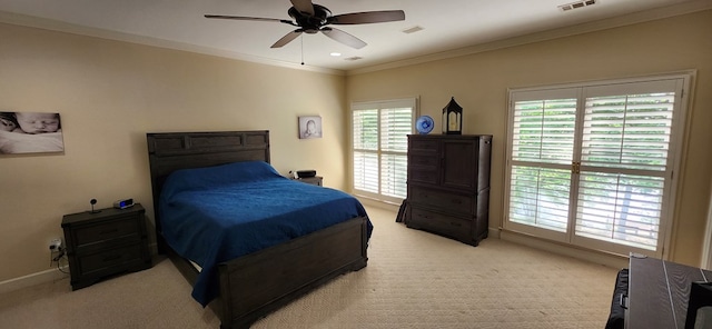 bedroom with visible vents, ornamental molding, light carpet, baseboards, and a ceiling fan