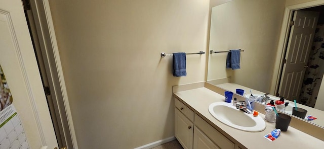 bathroom with vanity and baseboards