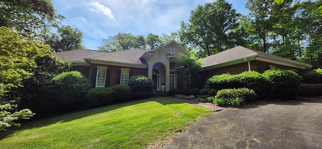 ranch-style house with a front lawn