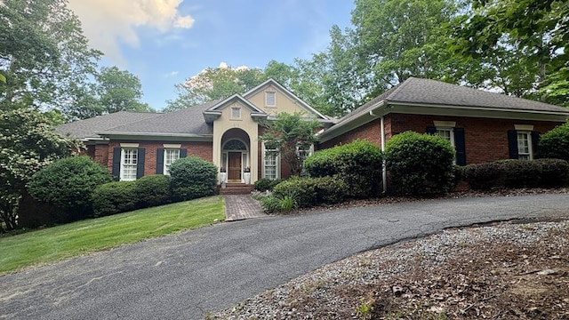 451 Sweetwater Dr, Cataula, GA 31804 - view of front of house with brick siding, a shingled roof, and a front lawn