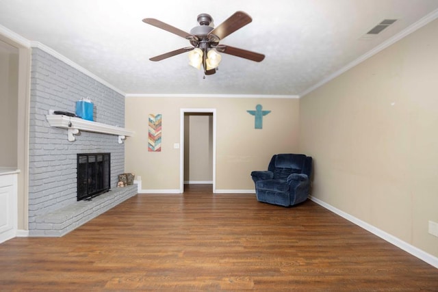7635 Edgewater Dr, Columbus, GA 31904 - living room featuring crown molding, wood finished floors, a ceiling fan, a fireplace, and baseboards