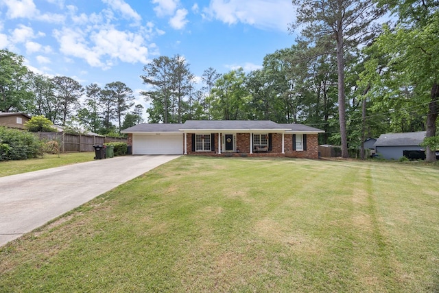 ranch-style home with driveway, a garage, brick siding, fence, and a front lawn