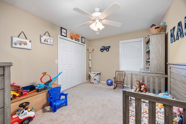 carpeted bedroom with ceiling fan, baseboards, and a closet