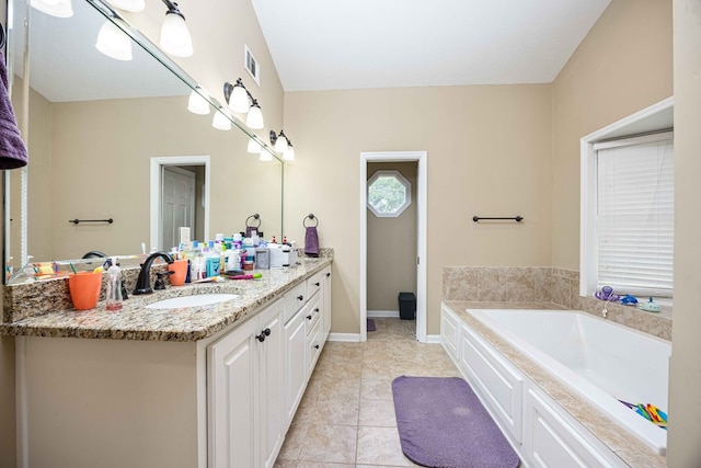 full bath with vanity, a garden tub, visible vents, baseboards, and tile patterned floors