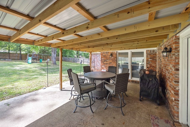 view of patio with outdoor dining area, a fenced backyard, and a playground