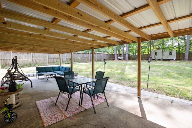 view of patio with a fenced backyard, an outbuilding, a storage shed, and an outdoor hangout area