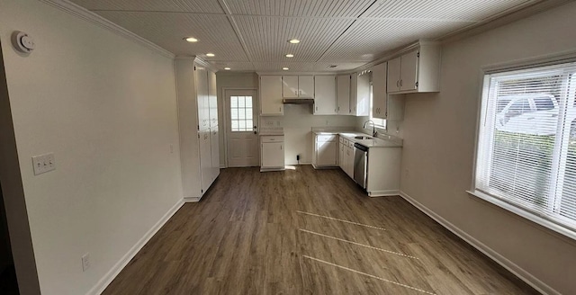 kitchen with dishwasher, light countertops, dark wood finished floors, and baseboards