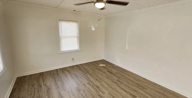 unfurnished room featuring ceiling fan, wood finished floors, visible vents, and ornamental molding