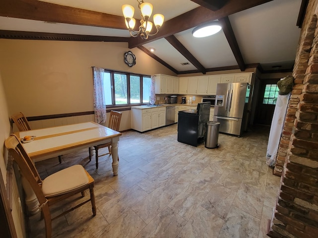 7505 Beaver Run Rd, Midland, GA 31820 - kitchen with appliances with stainless steel finishes, white cabinets, a chandelier, a kitchen island, and decorative light fixtures