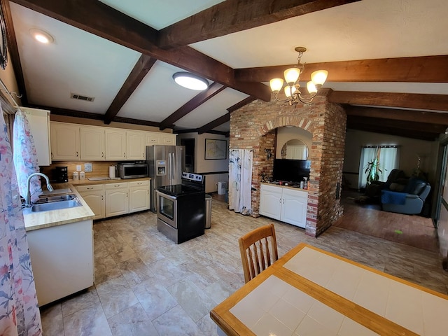 7505 Beaver Run Rd, Midland, GA 31820 - kitchen featuring stainless steel microwave, a chandelier, white cabinets, pendant lighting, and light countertops