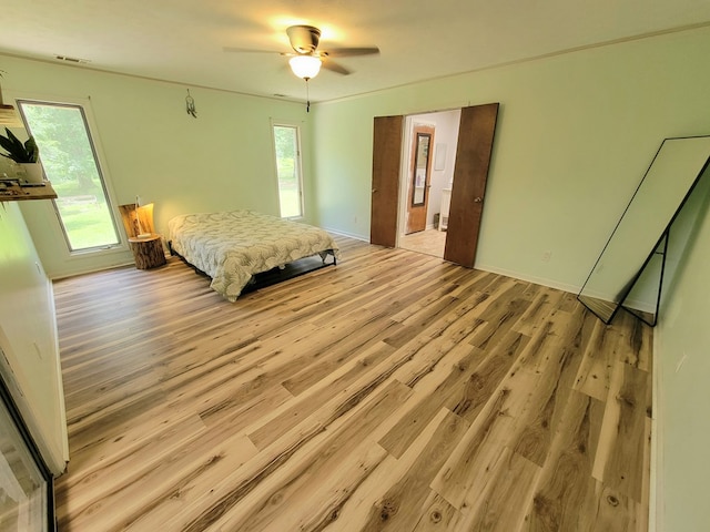 7505 Beaver Run Rd, Midland, GA 31820 - bedroom featuring wood finished floors, multiple windows, and ceiling fan