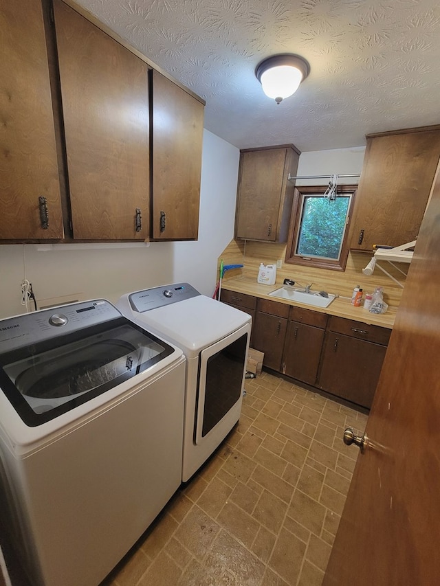 7505 Beaver Run Rd, Midland, GA 31820 - laundry room with washing machine and clothes dryer, cabinet space, brick patterned floors, and a textured ceiling