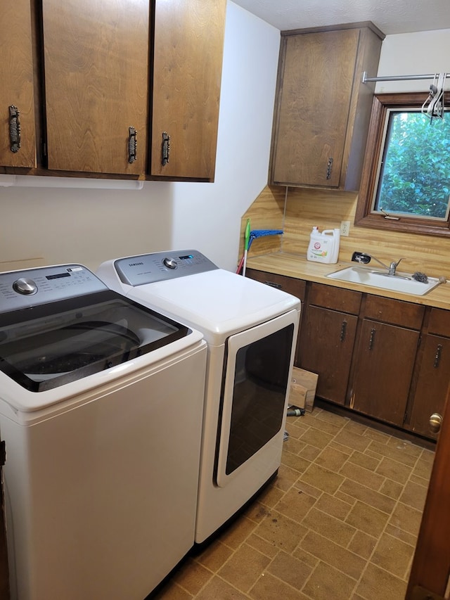 7505 Beaver Run Rd, Midland, GA 31820 - washroom featuring washing machine and clothes dryer, cabinet space, and brick patterned floors
