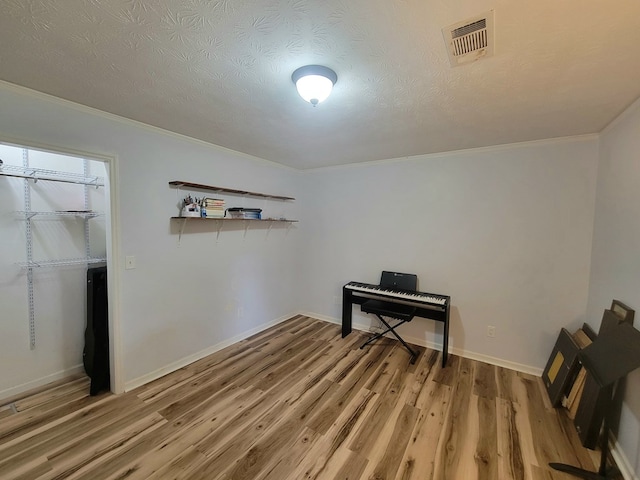 7505 Beaver Run Rd, Midland, GA 31820 - living area with crown molding, light wood finished floors, and a textured ceiling