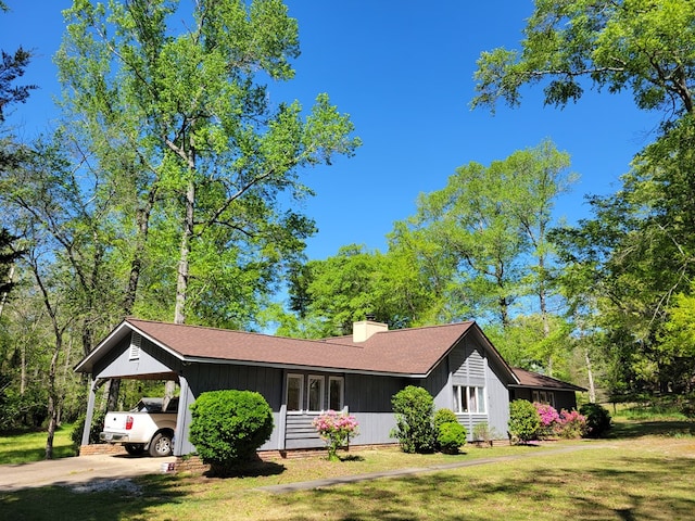 7505 Beaver Run Rd, Midland, GA 31820 - view of front of property featuring a front yard, an attached carport, driveway, a chimney, and roof with shingles