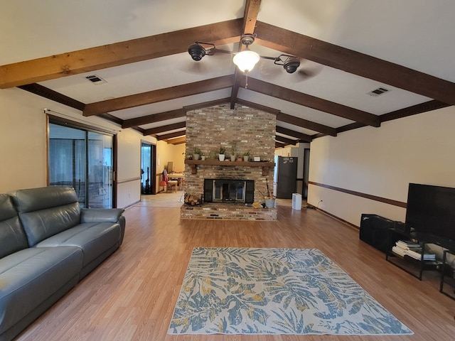 7505 Beaver Run Rd, Midland, GA 31820 - living area with wood finished floors, a ceiling fan, and a fireplace