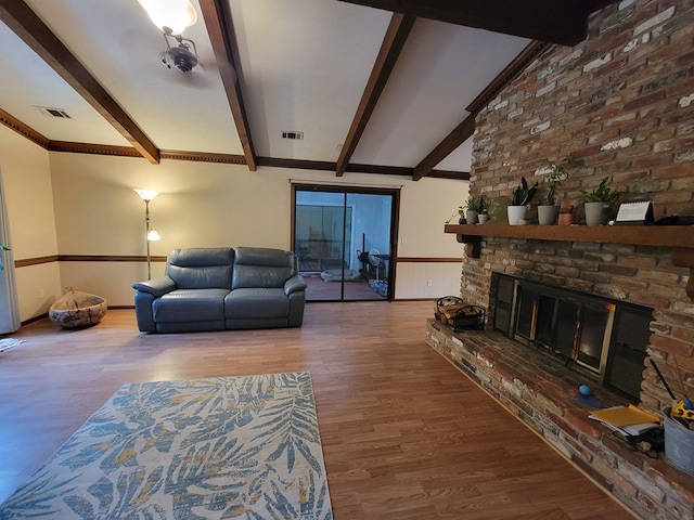 7505 Beaver Run Rd, Midland, GA 31820 - living area with wood finished floors, beam ceiling, and a fireplace