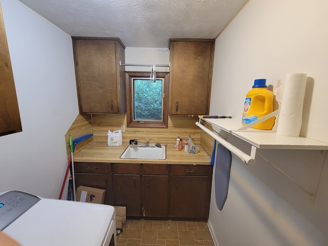 7505 Beaver Run Rd, Midland, GA 31820 - kitchen featuring light countertops, washer / dryer, dark brown cabinetry, and tasteful backsplash