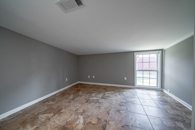 unfurnished room with visible vents and baseboards