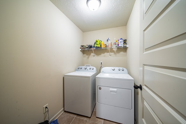9742 Wooldridge Heights Dr, Fortson, GA 31808 - laundry area with dark tile patterned floors, laundry area, a textured ceiling, baseboards, and separate washer and dryer