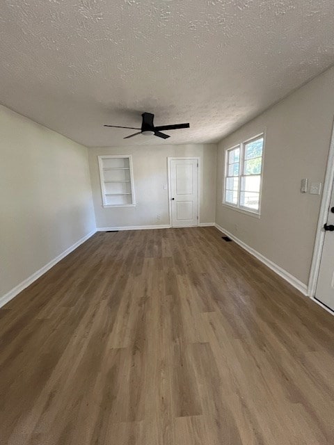 3015 Walker St, Columbus, GA 31903 - unfurnished bedroom with a textured ceiling, wood finished floors, and a ceiling fan