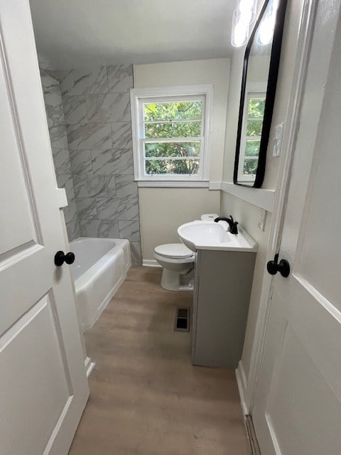 3015 Walker St, Columbus, GA 31903 - full bath with vanity, wood finished floors, and washtub / shower combination