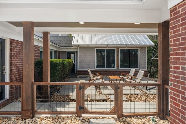 wooden terrace with a fenced front yard and a gate