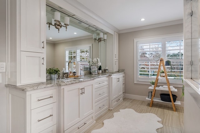 bathroom featuring recessed lighting, vanity, crown molding, and baseboards