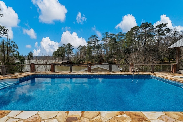 view of pool with a fenced in pool and fence