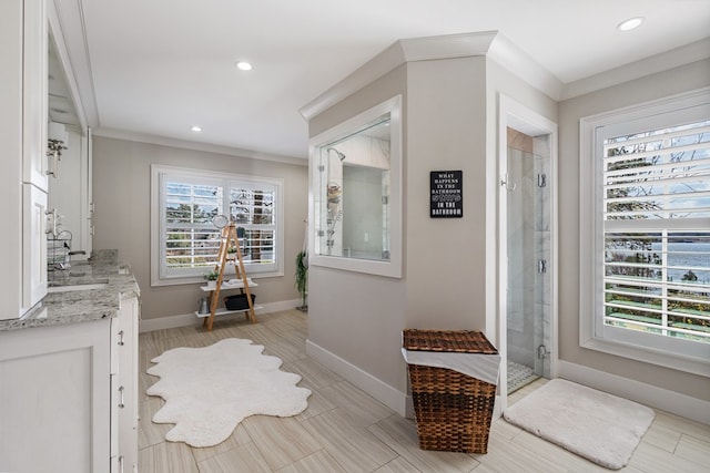 interior space featuring recessed lighting, a stall shower, baseboards, and ornamental molding