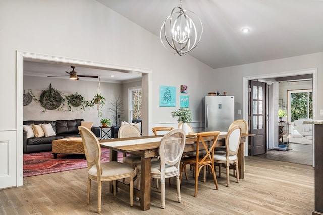 dining room with recessed lighting, high vaulted ceiling, light wood-style flooring, and ceiling fan with notable chandelier