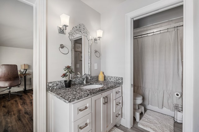 full bath with shower / tub combo, toilet, wood finished floors, and vanity