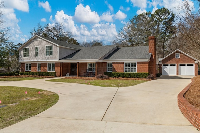 view of front of property with a garage, brick siding, and a front yard