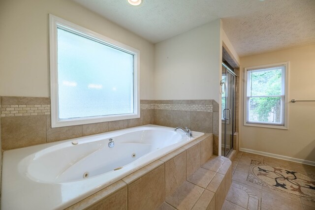 1820 Overlook St, Columbus, GA 31906 - bathroom featuring a jetted tub, a stall shower, and a textured ceiling