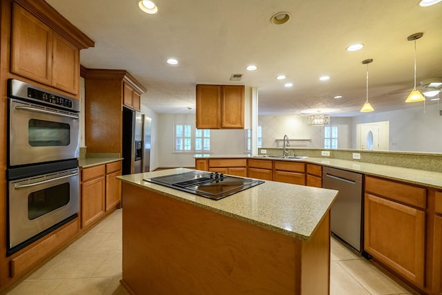 1820 Overlook St, Columbus, GA 31906 - kitchen with appliances with stainless steel finishes, recessed lighting, brown cabinetry, a kitchen island, and plenty of natural light