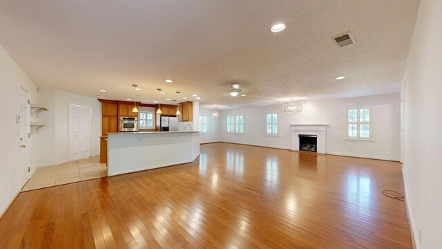 1820 Overlook St, Columbus, GA 31906 - unfurnished living room featuring plenty of natural light, light wood-style floors, recessed lighting, and a fireplace
