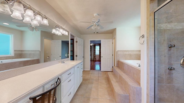 1820 Overlook St, Columbus, GA 31906 - bathroom featuring ceiling fan, vanity, tile patterned flooring, and a garden tub