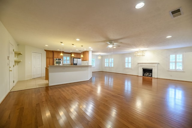 1820 Overlook St, Columbus, GA 31906 - unfurnished living room featuring ceiling fan, recessed lighting, a brick fireplace, and light wood finished floors
