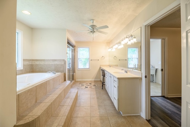 1820 Overlook St, Columbus, GA 31906 - bathroom with a garden tub, ceiling fan, double vanity, a stall shower, and tile patterned flooring