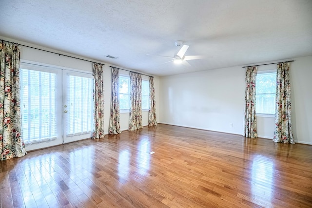 1820 Overlook St, Columbus, GA 31906 - empty room featuring a ceiling fan, wood finished floors, a textured ceiling, and french doors