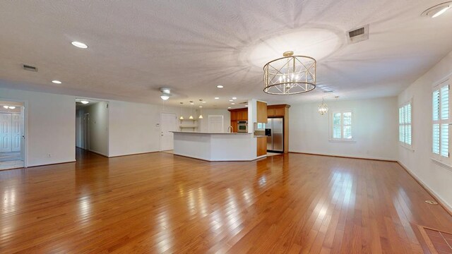 1820 Overlook St, Columbus, GA 31906 - unfurnished living room featuring a chandelier, light wood-style floors, and recessed lighting