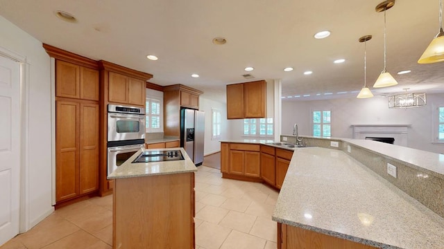 1820 Overlook St, Columbus, GA 31906 - kitchen featuring stainless steel appliances, recessed lighting, a center island, a fireplace, and light stone counters