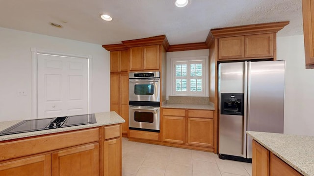 1820 Overlook St, Columbus, GA 31906 - kitchen with stainless steel appliances, light tile patterned floors, recessed lighting, and brown cabinetry